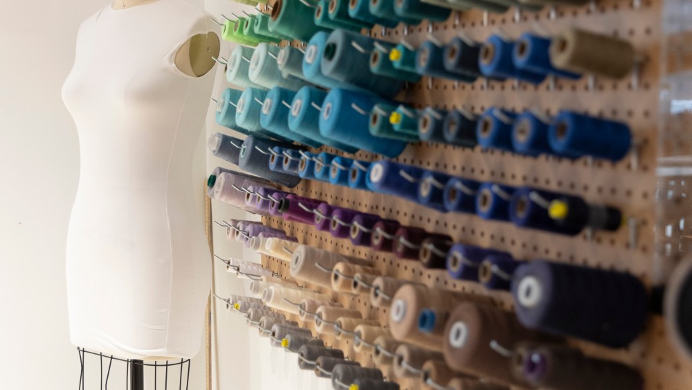 Inside the Hope for Flowers studio space, complete with a rainbow-hue assortment of sewing thread.
